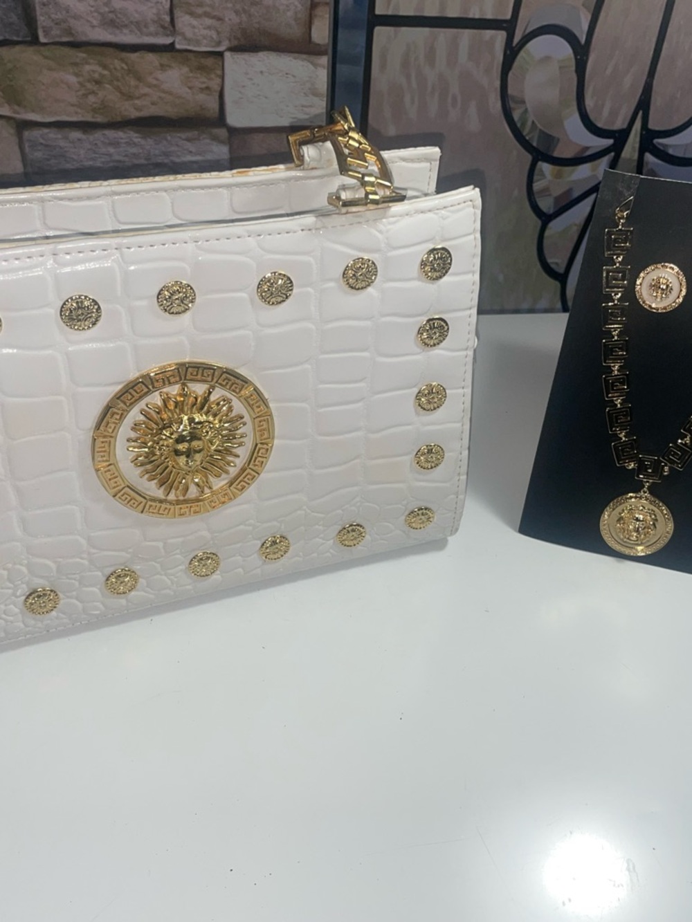 White Croc-Embossed Clutch with Gold Medallion Accents
